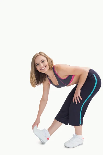 Portrait of young woman doing stretching exercise — Stock Photo, Image