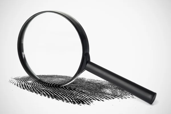 Magnifying glass with fingerprint — Stock Photo, Image