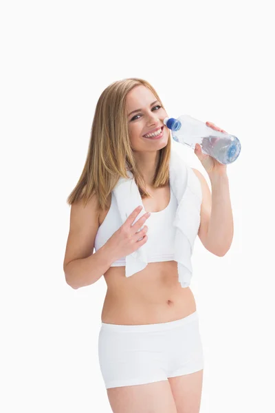 Портрет улыбающейся женщины с полотенцем на шее и питьевой водой — стоковое фото