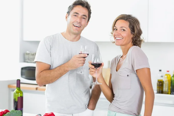 Lachende paar genieten van rode wijn samen — Stockfoto