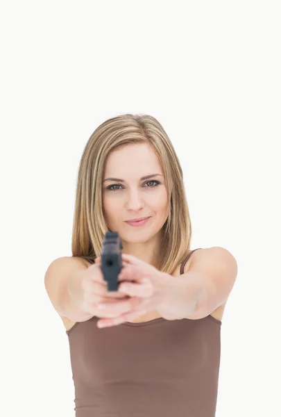Portrait of casual woman aiming gun towards you — Stock Photo, Image