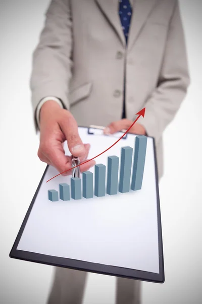 Businessman holding clipboard with graph hologram — Stock Photo, Image