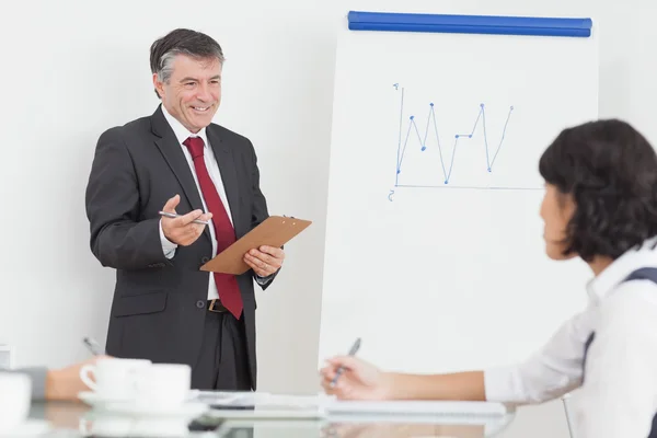 Businessman explaining to his colleague with big smile — Stock Photo, Image