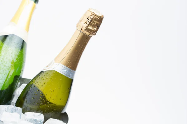 Two champagne bottles chilling on ice — Stock Photo, Image