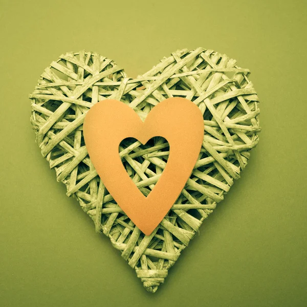 Wicker heart ornament with yellow paper cut out — Stock Photo, Image
