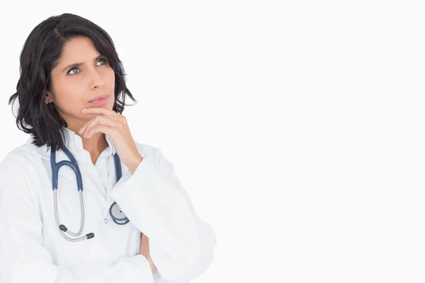 Doctor thinking hand to the chin — Stock Photo, Image