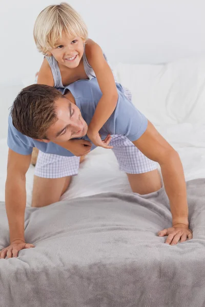 Father giving a piggy back to his son — Stock Photo, Image
