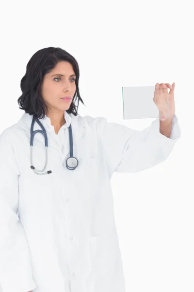 Female doctor looking at virtual clear screen — Stock Photo, Image