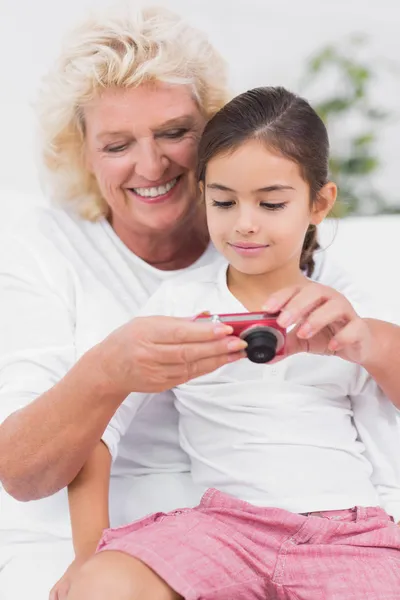 Petite-fille et grand-mère regardant des photos — Photo