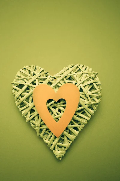 Wicker heart ornament with green paper cut out — Stock Photo, Image