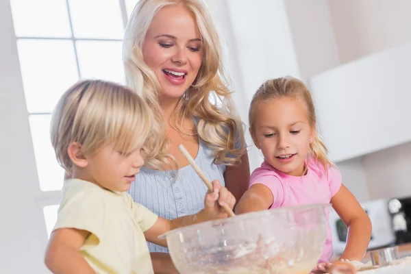 Children mixing the dough bowl with spoon — Stock Photo, Image