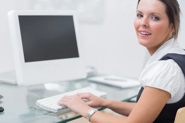 Confident female executive using computer at office Stock Picture