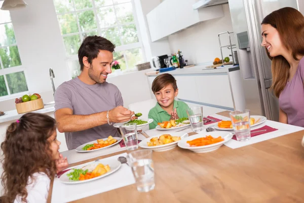 Father serving vegetables to son Stock Picture
