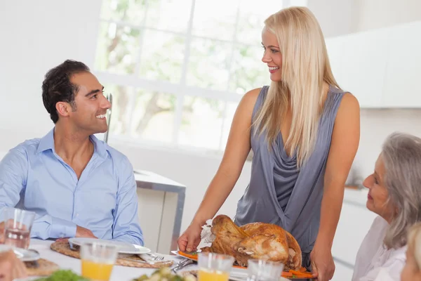 Happy wife bringing turkey to the table Stock Photo