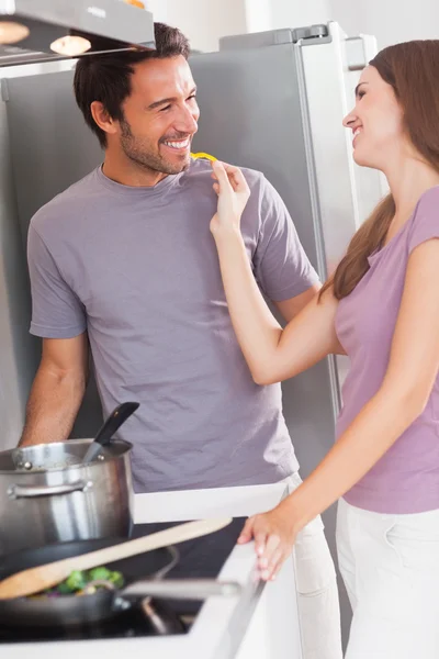 Woman feeding man with a yellow pepper — Stock Photo, Image