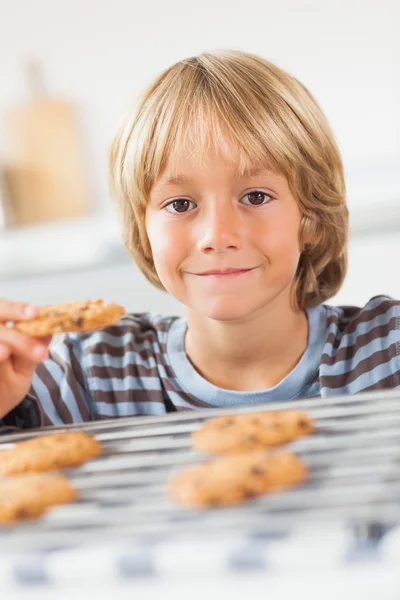 Smiling boy holding a cookie — Stock Photo, Image