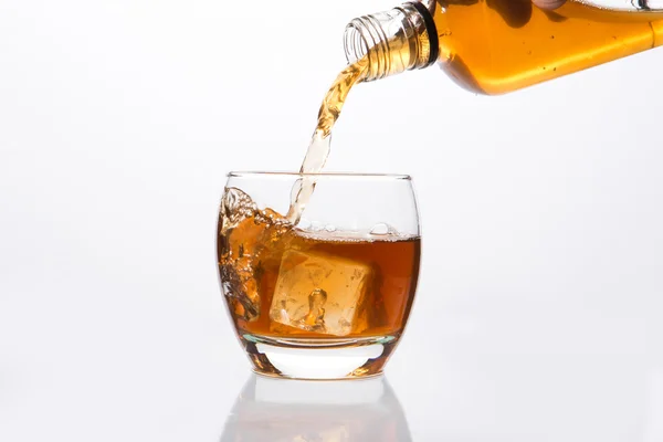 Whisky pouring into glass — Stock Photo, Image