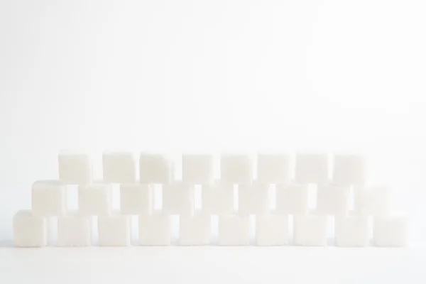Sugar cubes piled up together — Stock Photo, Image