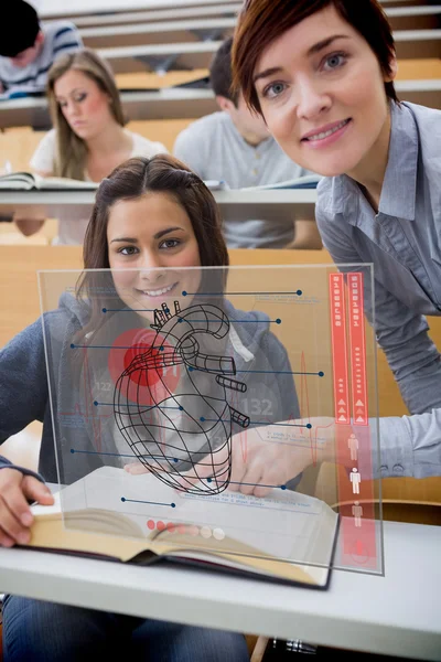 Teacher and student looking futuristic interface during lecture — Stock Photo, Image