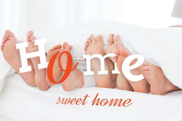 Family's feet in the bed — Stock Photo, Image