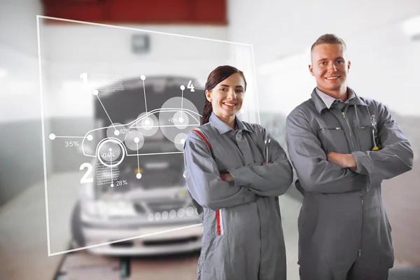 Two mechanics standing in front of a futuristic interface — Stock Photo, Image