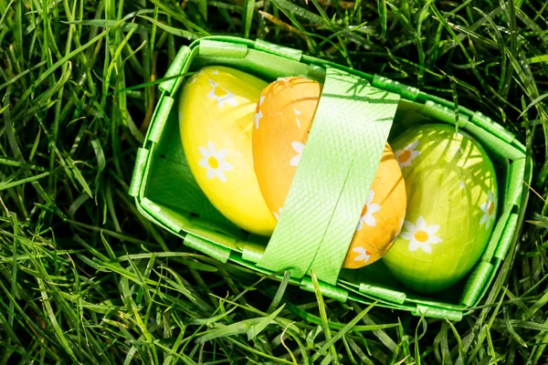 Three easter eggs in a basket — Stock Photo, Image