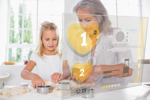 Grandmother and granddaughter baking with interface — Stock Photo, Image