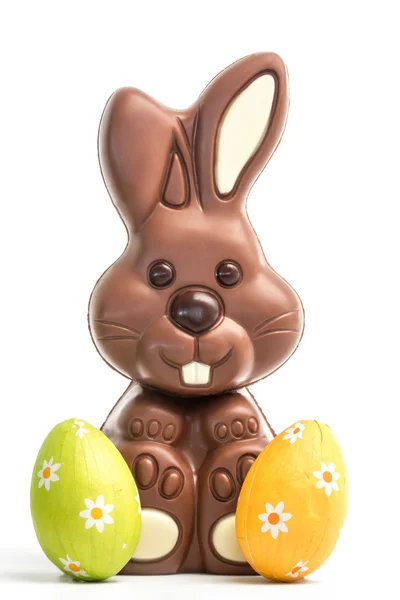 Cute chocolate bunny with two easter eggs — Stock Photo, Image