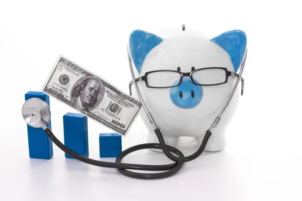 Blue and white piggy bank wearing glasses and stethoscope — Stock Photo, Image