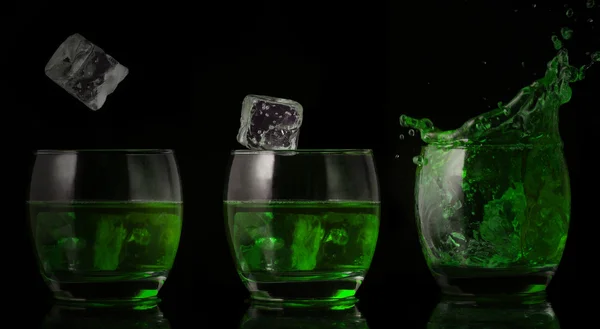 Serial arrangement of ice falling into glass of green liquid — Stock Photo, Image