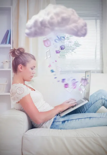 Woman working on laptop on the couch — Stock Photo, Image