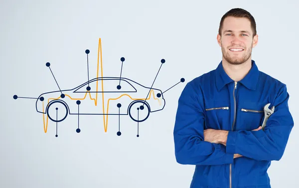 Portrait of a young mechanic next to background with car — Stock Photo, Image