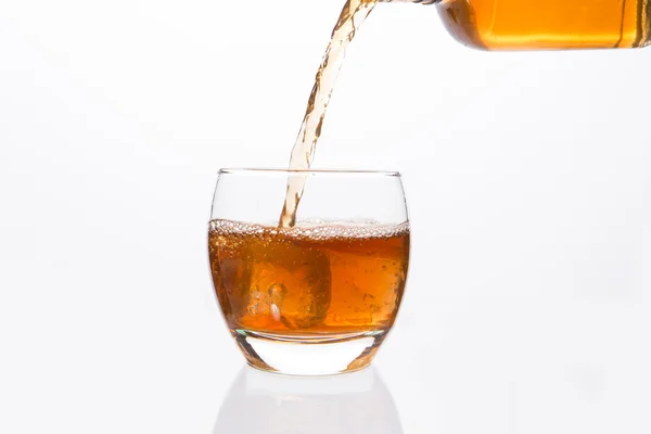 Whisky bottle pouring into glass — Stock Photo, Image