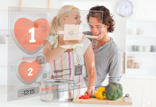 Cute couple making dinner using interface instructions — Stock Photo, Image
