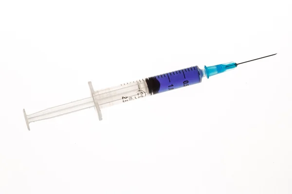 Hypodermic needle with purple liquid — Stock Photo, Image