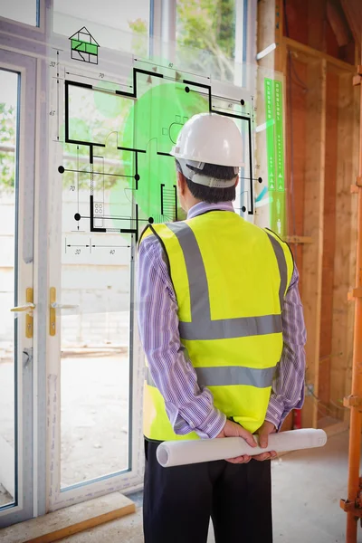 Architect looking at interface with house plan — Stock Photo, Image