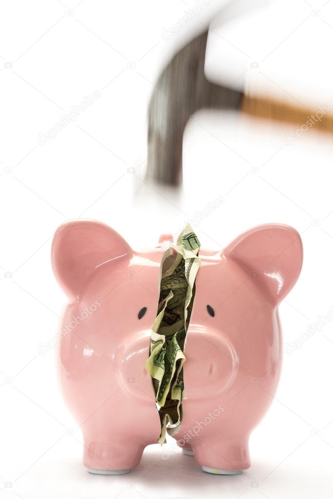 Hammer breaking piggy bank with money inside — Stock Photo