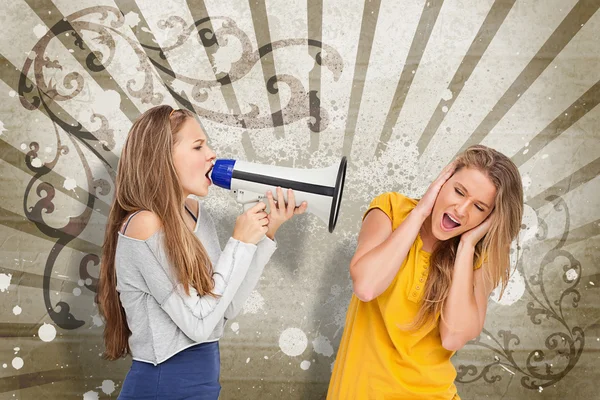 Girl shouting at another through a megaphone — Stock Photo, Image