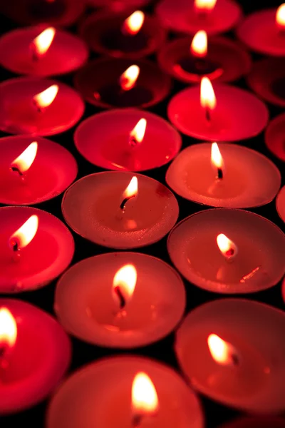 Red candles lighting up the dark — Stock Photo, Image