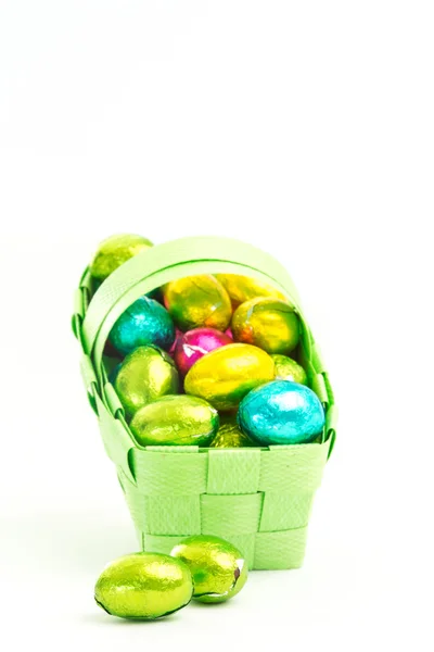 Foil wrapped easter eggs in a basket — Stock Photo, Image