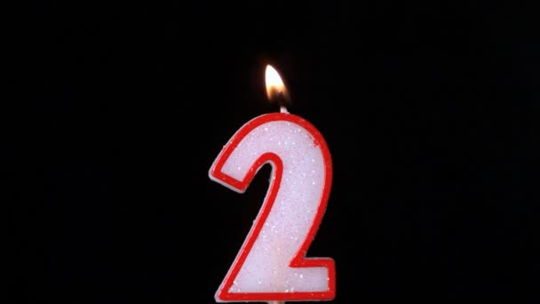 Two birthday candle flickering and extinguishing on black background — Stock Video