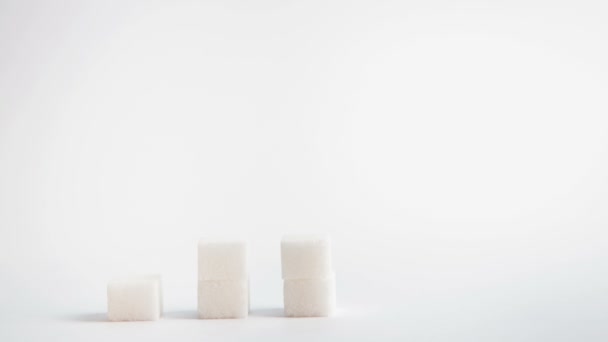 Towers of sugar cubes and dice spelling diabetes stacking up — Stock Video