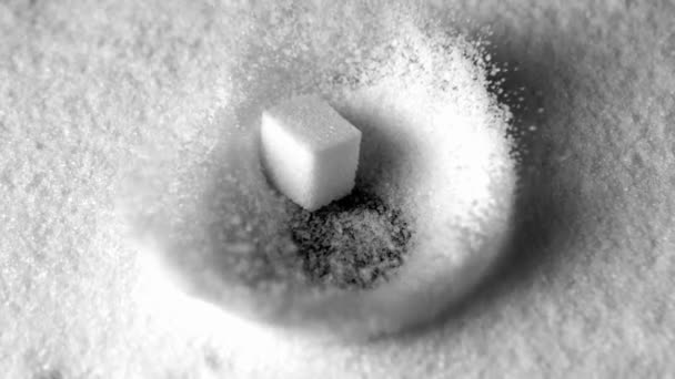 Sugar cube falling in pile of sugar — Stock Video