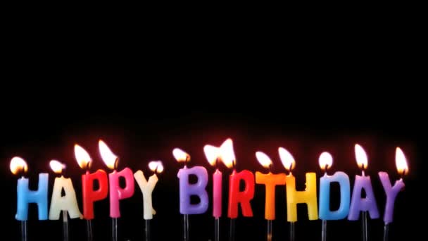 Colourful happy birthday candles being blown out on black background — Stock Video