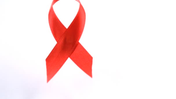 Red Aids awareness ribbon dropping down — Stock Video