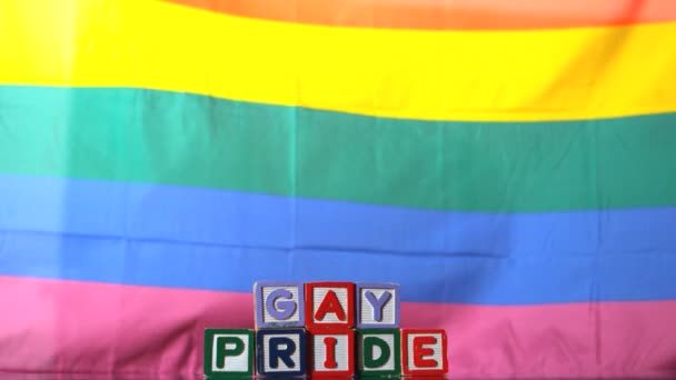 Σημαία ουράνιο τόξο που φυσά στο αεράκι με γκέι υπερηφάνειας μπλοκ — Αρχείο Βίντεο