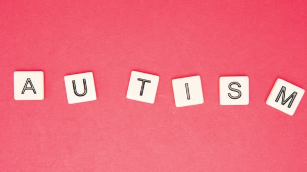 Autism spelled out in letter pieces among many — Stock Video