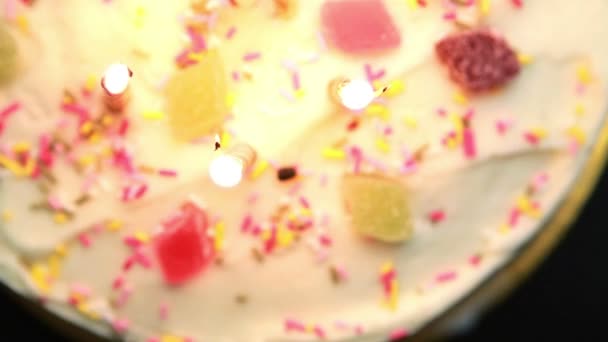 Revolving birthday cake with candles blown out — Stock Video