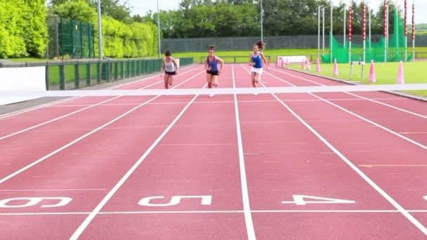 Three woman running on a track and crossing finish line — Stock Video