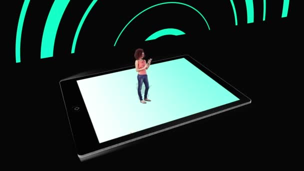 Girl walking on and using tablet pc with holographic application icons on black background — Stock Video